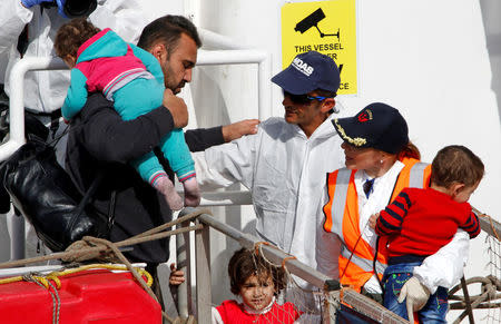 Migrants disembark from MOAS vessel Phoenix in the Sicilian harbour of Catania, Italy, May 6, 2017. REUTERS/Antonio Parrinello