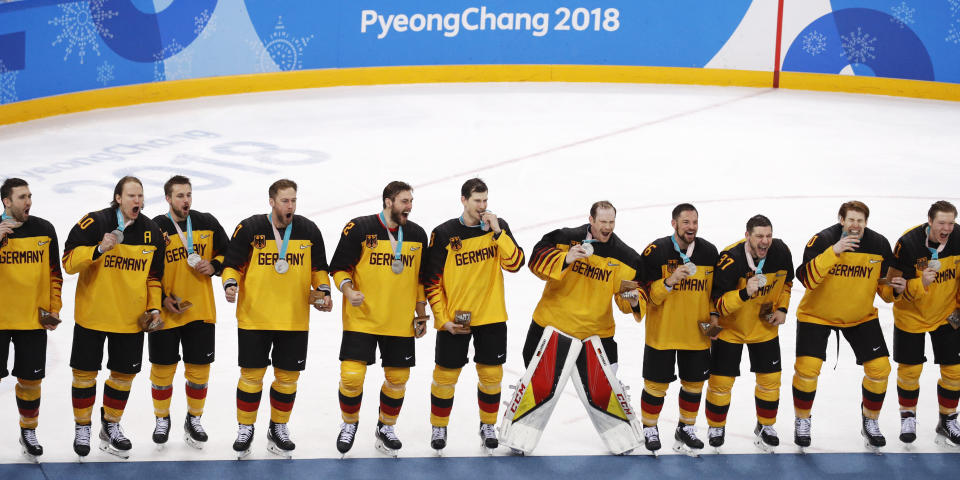 FILE- Germany players celebrate after receiving their silver medals at the 2018 Winter Olympics, Sunday, Feb. 25, 2018, in Gangneung, South Korea. Four years after an improbable run to the Olympic final and that ended with a silver medal, Germany is back at the 2022 Beijing Olympics without NHL players looking to duplicate that effort. (AP Photo/Jae C. Hong, File)