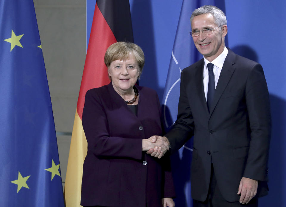 German Chancellor Angela Merkel, left, and NATO Secretary General Jens Stoltenberg, right, shake hands after a joint a press conference at the Chancellery in Berlin, Germany, Thursday, Nov. 7, 2019. (AP Photo/Michael Sohn)