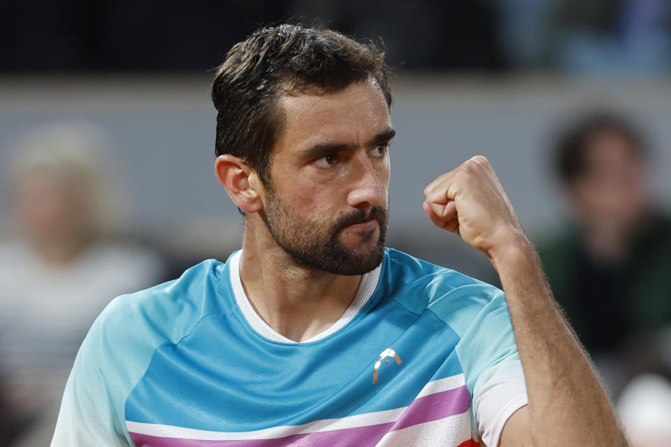 Croatia's Marin Cilic clenches his fist after winning a point as he plays Russia's Daniil Medvedev during their fourth round match of the French Open tennis tournament at the Roland Garros stadium Monday, May 30, 2022 in Paris. (AP Photo/Jean-Francois Badias)