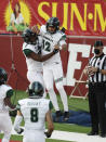 Hawaii quarterback Chevan Cordeiro, right, celebrates his touchdown with running back Dae Dae Hunter against Fresno State quarterback during the first half of an NCAA college football game in Fresno, Calif., Saturday, Oct. 24, 2020. (AP Photo/Gary Kazanjian)