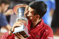 Serbia's Novak Đjoković kisses his trophy after winning his match with Argentina's Diego Sebastián Schwartzman during their final match at the Italian Open tennis tournament, in Rome, Monday, Sept. 21, 2020. (Alfredo Falcone/LaPresse via AP)