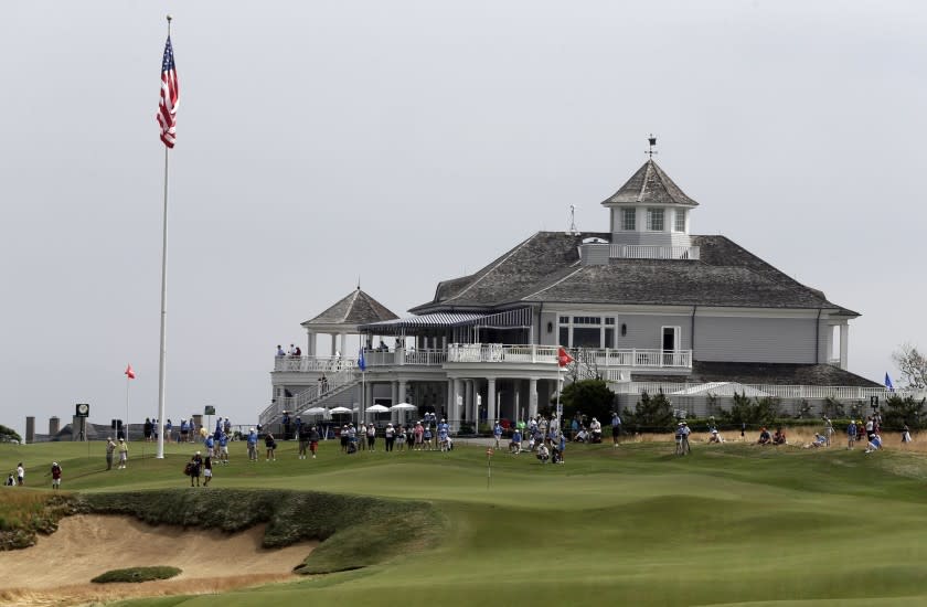 Fans watch golfers putt on the second hole during the first round of the U.S. Women's Open golf tournament at the Sebonack Golf Club Thursday, June 27, 2013, in Southampton, N.Y. (AP Photo/Frank Franklin II)