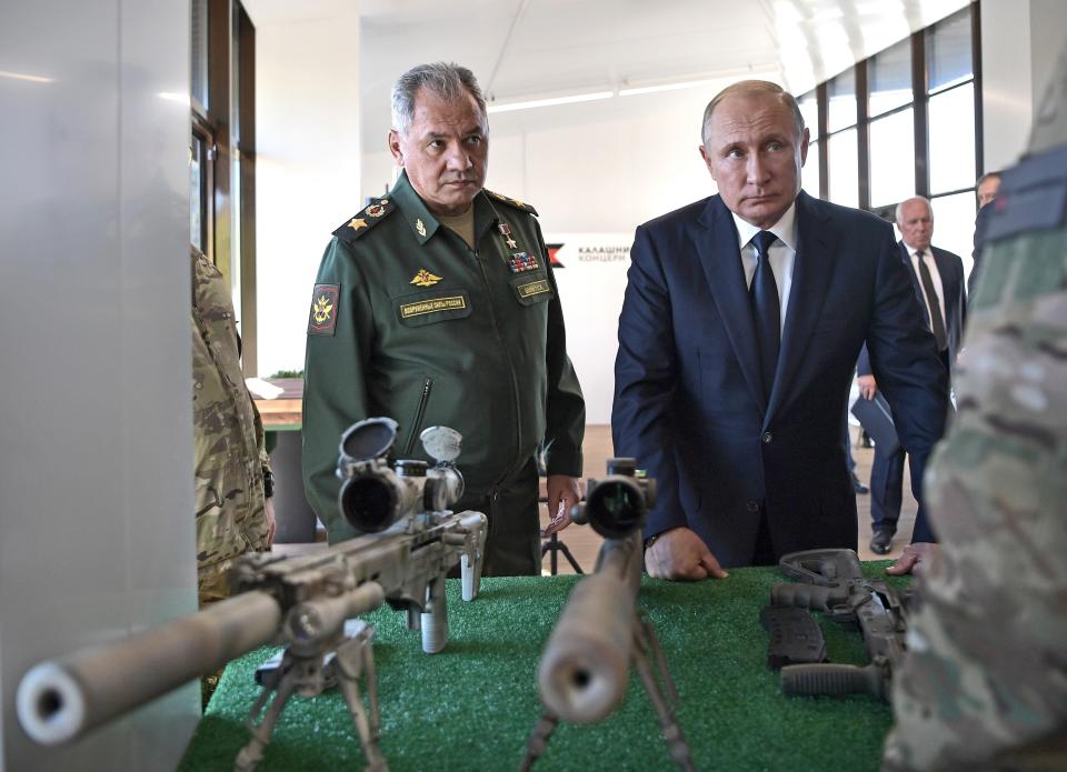 Russian President Vladimir Putin, right, and Russian Defense Minister Sergei Shoigu look at sniper rifles during a visit to the Patriot military exhibition center outside Moscow, Russia, Wednesday, Sept. 19, 2018. Putin chaired a meeting that focused on new arms programs. (Alexei Nikolsky, Sputnik, Kremlin Pool Photo via AP)