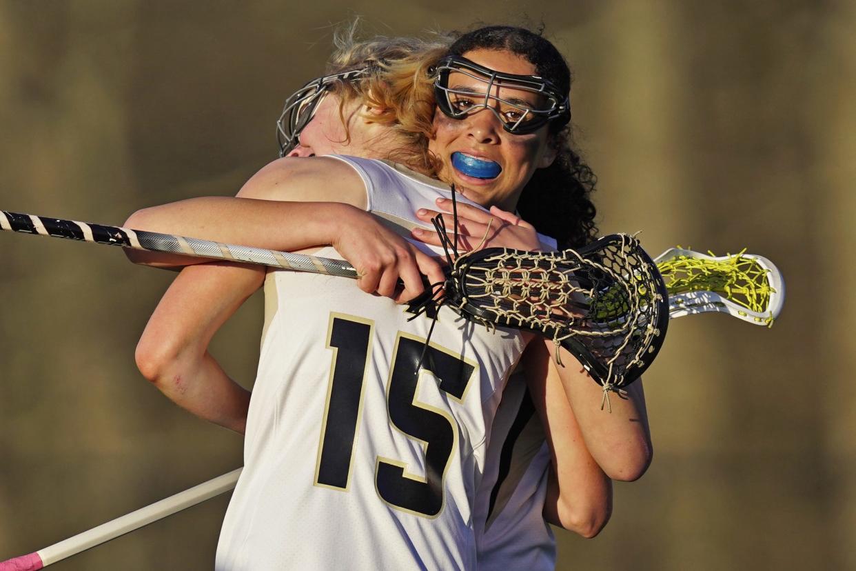 North Kingstown's Mya Macchioni gets a hug from teammate Cameryn Clarke during Friday's match against Chariho.