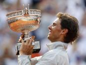 Rafael Nadal of Spain holds the trophy during the ceremony after defeating Novak Djokovic of Serbia during their men's singles final match to win the French Open Tennis tournament at the Roland Garros stadium in Paris June 8, 2014. REUTERS/Vincent Kessler