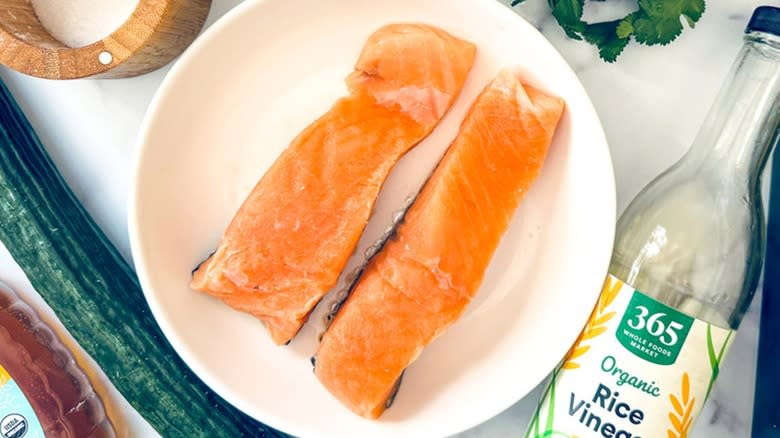 raw salmon fillets on white plate