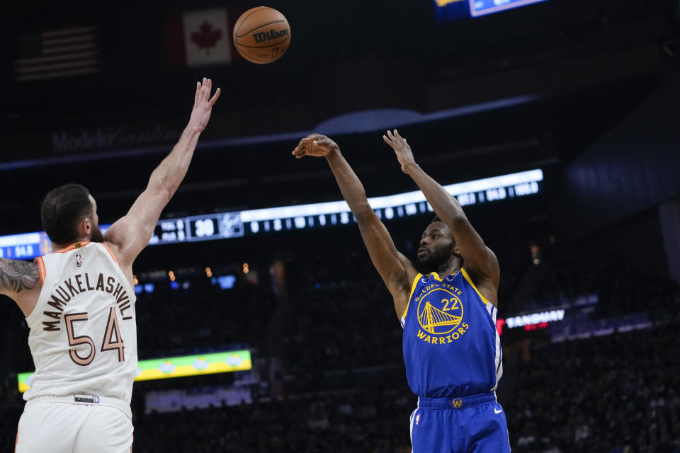 Golden State Warriors forward Andrew Wiggins (22) shoots a 3-point basket over San Antonio Spurs forward Sandro Mamukelashvili during the first half of an NBA basketball game Saturday, March 9, 2024, in San Francisco. (AP Photo/Godofredo A. Vásquez)
