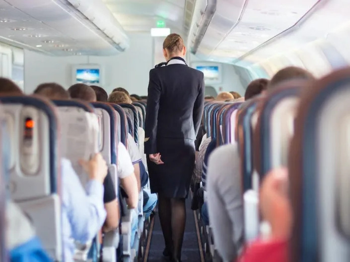 A flight attendant on an airplane.