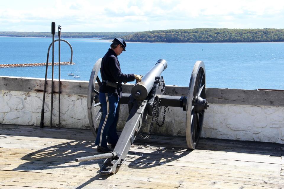 This Sept. 23, 2012 photo shows a cannon being loaded for a demonstration at Fort Mackinac on Mackinac Island, Mich., on Lake Huron. The fort, located on the island since 1780, was such an important military outpost for the Great Lakes region that the British retained control of it until 1796, well after the Americans had won the Revolutionary War. (AP Photo/Anick Jesdanun)