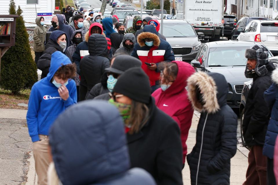 Hundreds of people wait in line down Mott Street in order  to get tested for COVID-19 at the old Brock Avenue fire station in New Bedford.