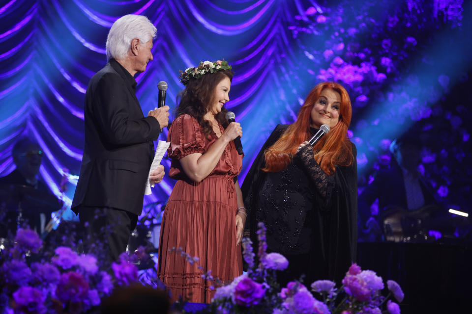 Larry Strickland, Ashley Judd, and Wynonna Judd speak onstage during CMT's 