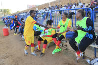 In this Wednesday, Dec. 11, 2019 photo, Sudanese , al-Difaa players sit on the bench durin a game with al-Difaa women teams in Omdurman, Khartoum's twin city, Sudan. The women's soccer league has become a field of contention as Sudan grapples with the transition from three decades of authoritarian rule that espoused a strict interpretation of Islamic Shariah law. (AP Photo)