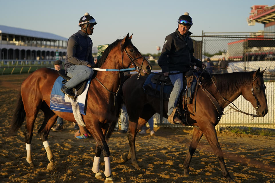 Preakness entrant Epicenter, left, the runner up in the Kentucky Derby horse race, leaves the track after a workout ahead of the Preakness Stakes Horse Race race at Pimlico Race Course, Wednesday, May 18, 2022, in Baltimore. (AP Photo/Julio Cortez)