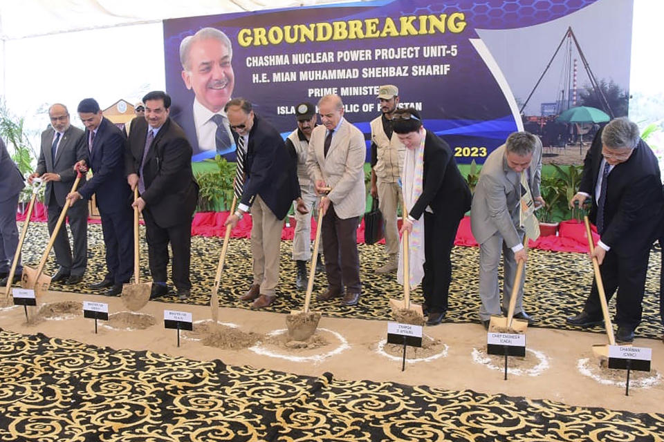 In this photo released by Press Information Department, Pakistan's Prime Minister Shehbaz Sharif, center, with unidentified Chinese officials dig during the groundbreaking ceremony of 5th Unit of Chashma Nuclear Power Plant (Chashma-5) in Chashma, Mianwali, Pakistan, Friday, July 14, 2023. Sharif launched the construction of a 1,200-megawatt Chinese-designed nuclear energy project, which will be built at a cost of $3.5 billion as part of the government efforts to generate more clean energy in the Islamic nation. (Press Information Department via AP)