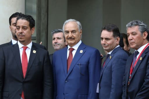 Marshal Khalifa Haftar, whose self-styled Libyan National Army dominates the country's east, stands with his delegation on the steps of the Elysee Palace as they leave following the International conference on Libya in Paris on May 29, 2018