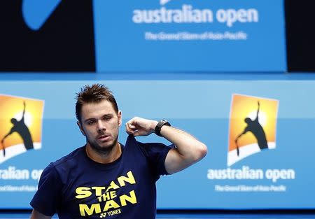 Defending Australian Open men's champion Stanislas Wawrinka of Switzerland walks onto court during a training session on Rod Laver Arena at Melbourne Park January 18, 2015. REUTERS/Issei Kato