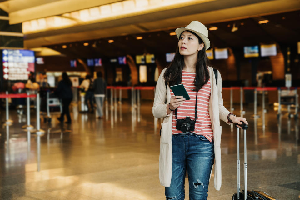 Pretty asian woman get holiday. charming beautiful girl decided going to place at foreign oversea country. Attractive lady feel happy relaxed wait for calling flight at airport lobby holding passport