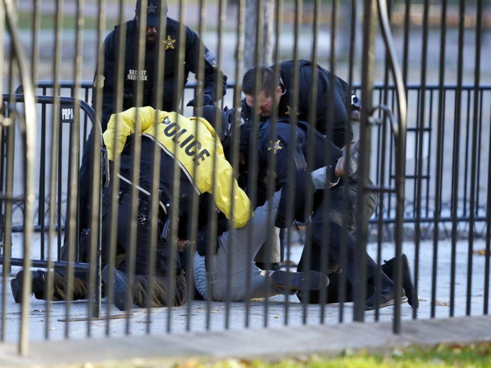 The man is subdued by the Secret Service after leaping the barrier at the White House: AP