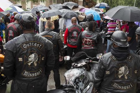 Members of the "Outcast" motorcycle club take part in a vigil in the neighborhood where teenager Michael Brown was shot in Ferguson, Missouri, August 16, 2014. REUTERS/Lucas Jackson