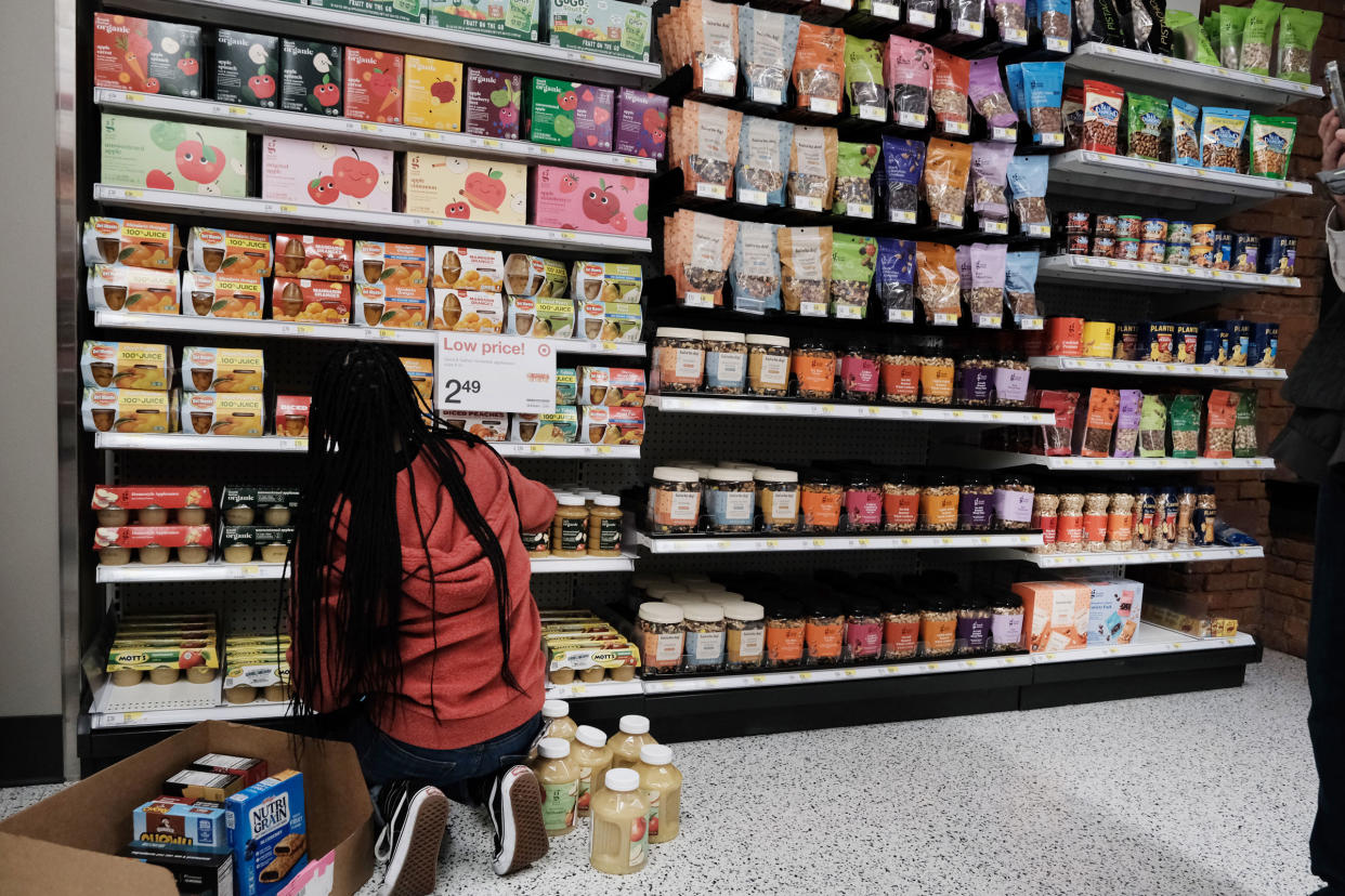 A woman stocks food at a Manhattan grocery store on Oct. 26, 2022 in New York City.