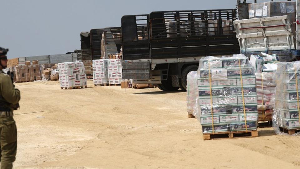 An Israeli soldier watches as aid trucks for the Gaza Strip are checked at the Erez border crossing.  Photo: May 1, 2024
