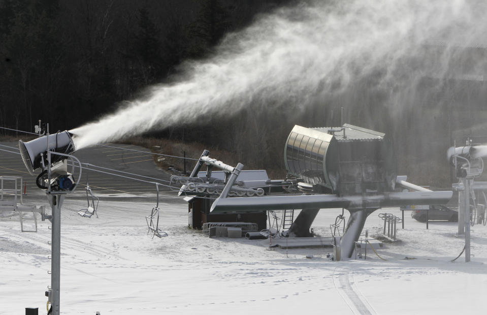This Nov. 15, 2012 photo shows a snow gun making fresh snow at the Stowe resort in Stowe, Vt. The ground might be bare, but ski areas across the Northeast are making big investments in high-efficiency snowmaking so they can open more terrain earlier and longer. (AP Photo/Toby Talbot)