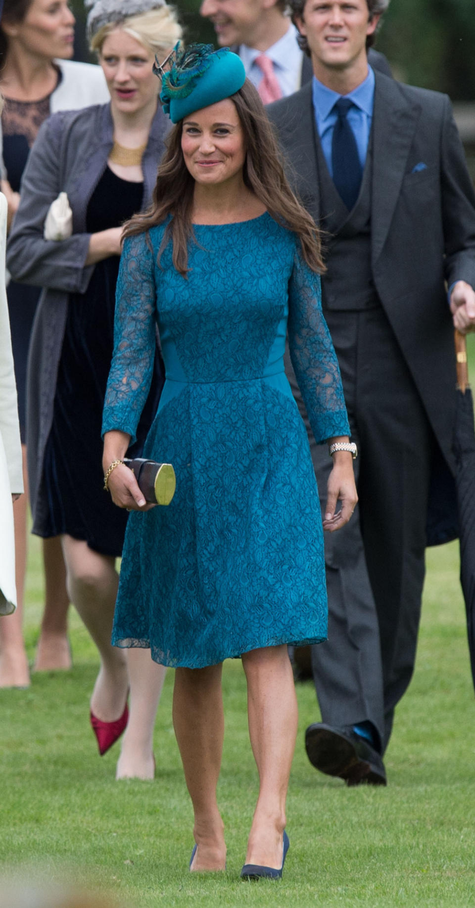 <p>Wearing a teal, lace Tabitha Webb dress to a wedding in 2013, Pippa took a leaf out of her sister’s book and added a hat as the finishing touch.<i> [Photo: PA Images]</i> </p>