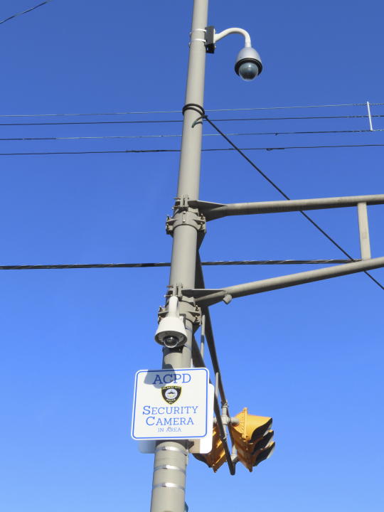 Security cameras look down on a street corner in Atlantic City, N.J., on Nov. 16, 2023. The city plans to add hundreds of additional security cameras to the 3,000 that already keep an electronic eye on the seaside gambling resort. (AP Photo/Wayne Parry)