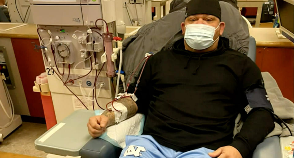 Chad Carswell wearing a mask while hooked up to a dialysis machine. 