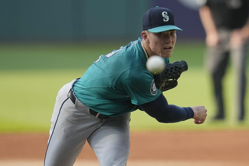 Seattle Mariners' Bryan Woo watches a throw to a Cleveland Guardians batter during the first inning of a baseball game Wednesday, June 19, 2024, in Cleveland. (AP Photo/Sue Ogrocki)