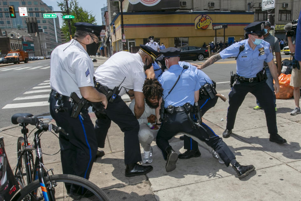 Philadelphia police tackle a man after he attacked Associated Press Photographer Matt Rourke as he was touring the business district with Philadelphia Mayor Jim Kenney and Police Commissioner Danielle Outlaw in Philadelphia on Thursday, June 4, 2020. (Alejandro A. Alvarez/The Philadelphia Inquirer via AP)