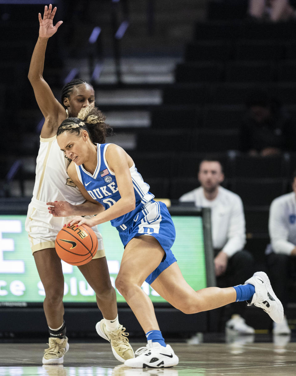 FILE - Duke guard Celeste Taylor (0) pushes her way past Wake Forest guard Kaia Harrison, left, in the second half of an NCAA college basketball game Thursday, Jan. 5, 2023, in Winston-Salem, N.C. With Duke rising to No. 9 in this week's AP Top 25, it marks only the second time since 2000 that each of neighboring schools Duke, North Carolina and North Carolina State have cracked the top 10 in the same season. (Allison Lee Isley/The Winston-Salem Journal via AP, File)