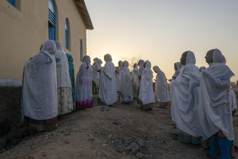 Orthodox Christian Tigrayan refugees who fled the conflict in the Ethiopia's Tigray pray in front of a church at Hamdeyat Transition Center near the Sudan-Ethiopia border, eastern Sudan, March 16, 2021. (AP Photo/Nariman El-Mofty)
