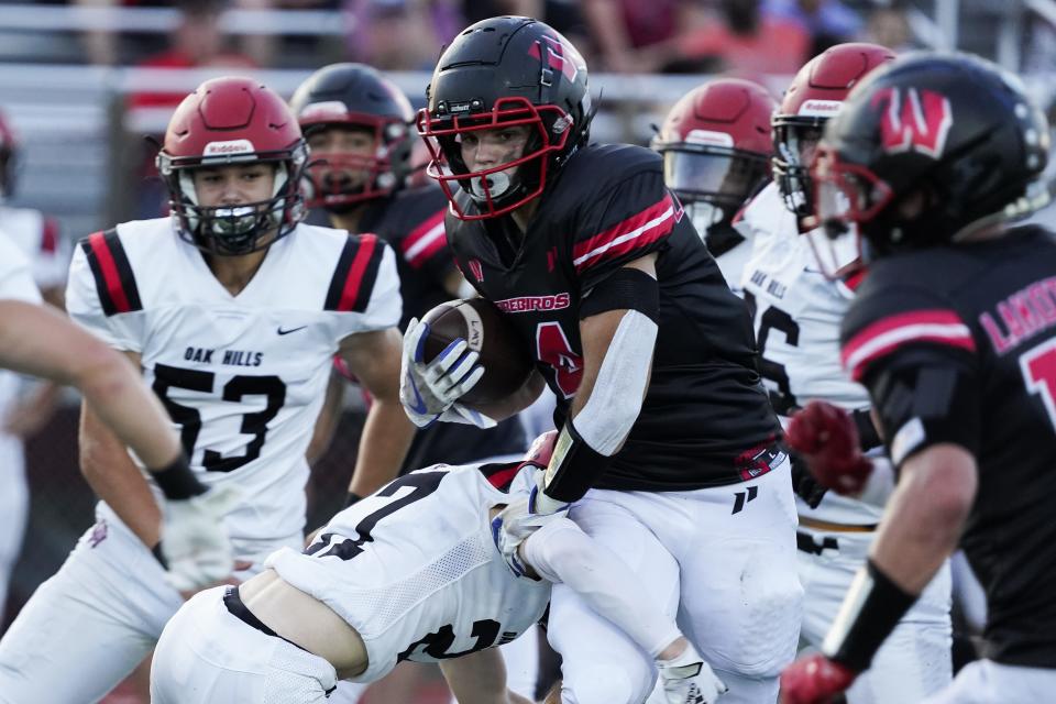 Lakota West wide receiver Trent Lloyd (4) carries the ball during the first quarter of the high school football game with Oak Hills  Friday, Sept. 9, 2022.