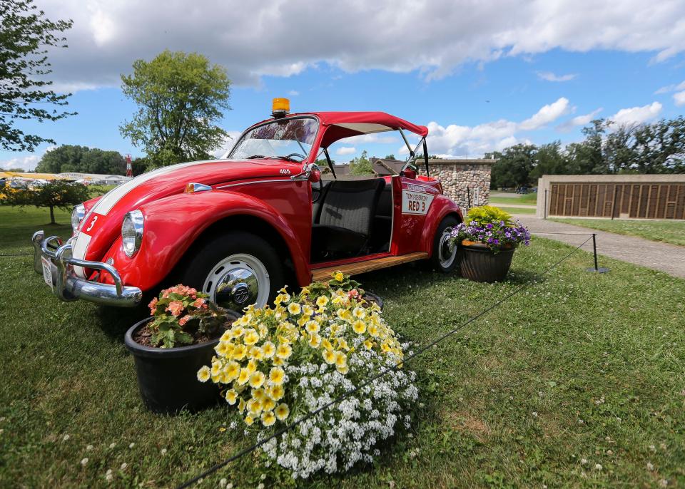 Former EAA Chairman Tom Poberezny's Volkswagen Beetle, "Red 3," is seen on display during Day 4 of EAA AirVenture July 28, near the Memorial Wall at Wittman Regional Airport in Oshkosh. Poberezny died July 25.