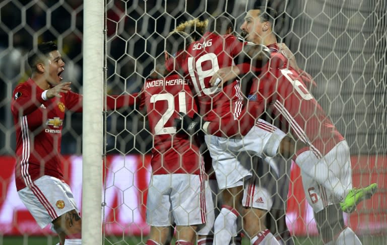 Manchester United players celebrate during their UEFA Europa League round of 16 football match against Rostov at Olimp-2 Arena in Rostov-on-Don on March 9, 2017