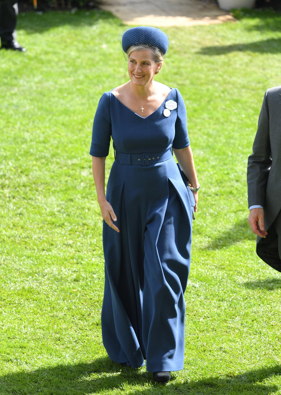 Sophie, Countess of Wessex wore a bespoke belted navy jumpsuit by Emilia Wickstead - <a href="https://fave.co/2ZyI2Ib" rel="noopener" target="_blank" data-ylk="slk:available in red here;elm:context_link;itc:0;sec:content-canvas" class="link ">available in red here</a> with a <a href="https://fave.co/2ZFVaLD" rel="noopener" target="_blank" data-ylk="slk:Jane Taylor;elm:context_link;itc:0;sec:content-canvas" class="link ">Jane Taylor</a> veiled hat. <em>[Photo: PA]</em>