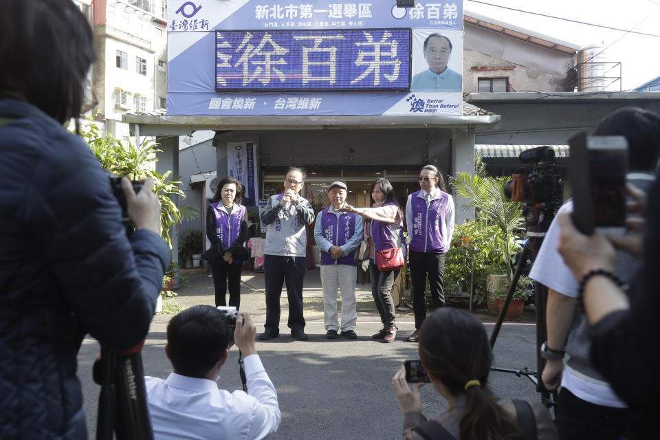 Chui Pak-tai, center, a Taiwanese of Hong Kong descent, attends his press conference in front of his campaign headquarters in New Taipei City, Taiwan, on Dec. 8, 2023. At 72, Chui, a former Hong Kong pro-democracy district councilor who secured Taiwan residency 11 years ago, is running for legislative office. Although he faces long odds, his campaign draws attention to the immigration challenges of the Hong Kong diaspora.(AP Photo/Chiang Ying-ying)
