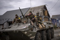 Ukrainian soldiers drive on an armored military vehicle in the outskirts of Kyiv, Ukraine, Saturday, March 5, 2022. (AP Photo/Emilio Morenatti)