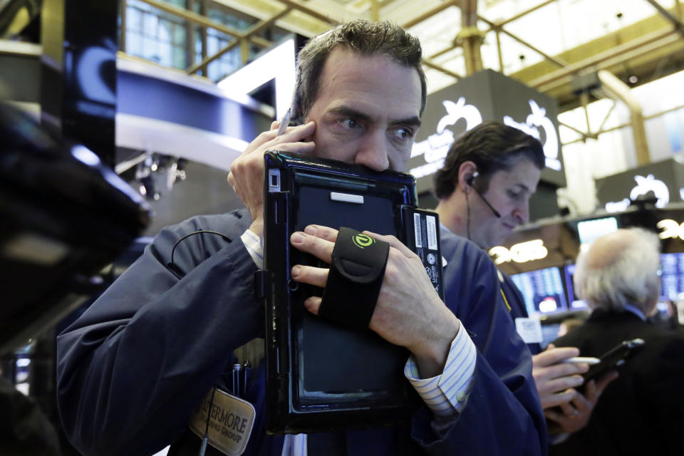 Traders Gregory Rowe, left, and Thomas Donato work on the floor of the New York Stock Exchange, Wednesday, Jan. 31, 2018. (AP Photo/Richard Drew)