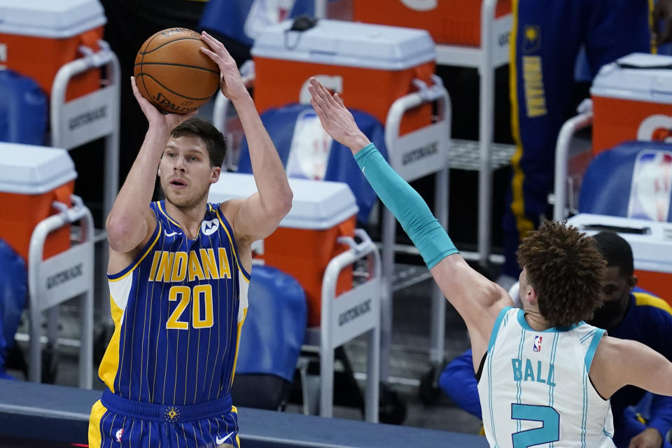 Indiana Pacers' Doug McDermott (20) shoots against Charlotte Hornets' LaMelo Ball (2) during the first half of an NBA basketball Eastern Conference play-in game Tuesday, May 18, 2021, in Indianapolis. (AP Photo/Darron Cummings)