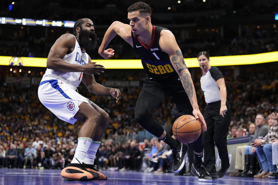 Denver Nuggets forward Michael Porter Jr. (1) drives to the basket against Los Angeles Clippers guard James Harden (1) during the first half of an NBA basketball in-season tournament game Tuesday, Nov. 14, 2023, in Denver. (AP Photo/Jack Dempsey)