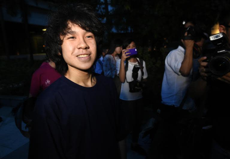 Teenager Amos Yee leaves Singapore's state courthouse on bail after he was convicted of two criminal charges on May 12, 2015