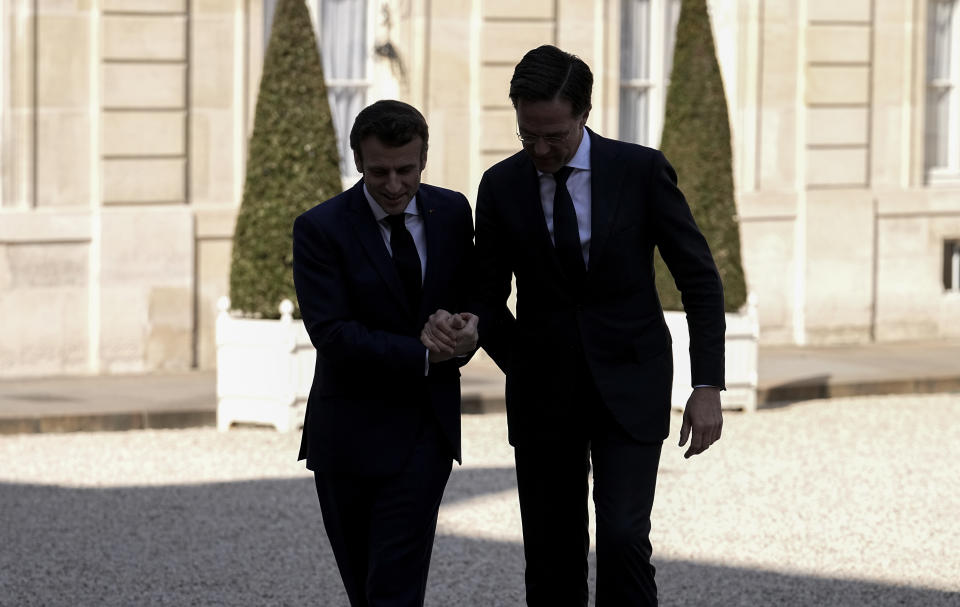 French President Emmanuel Macron, left, and Netherlands Prime Minister Mark Rutte are silhouetted as they arrive to meet reporters before their meeting at the Elysee Palace in Paris, Wednesday, March 9, 2022. Netherlands Prime Minister Mark Rutte is for bileteral talks in Paris. (AP Photo/Michel Euler)
