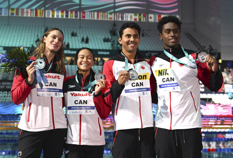 Silver medalist team of Canada poses with their medals after the Mixed 4x100m Freestyle Relay at the 19th FINA World Championships in Budapest, Hungary, Friday, June 24, 2022. (AP Photo/Anna Szilagyi)