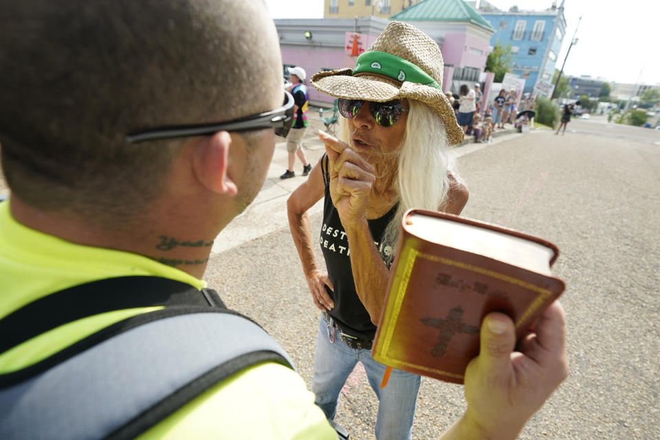 Derenda Hancock, right, co-director of the Jackson Women's Health Organization clinic patient escorts, better known as the Pink House defenders, argues with anti-abortion advocate Boris Campos outside the Jackson Women's Health Organization clinic in Jackson, Miss., Thursday, July 7, 2022. The clinic was the only facility that performed abortions in the state. However, on Tuesday, a chancery judge rejected a request by the clinic to temporarily block a state law banning most abortions. (AP Photo/Rogelio V. Solis)