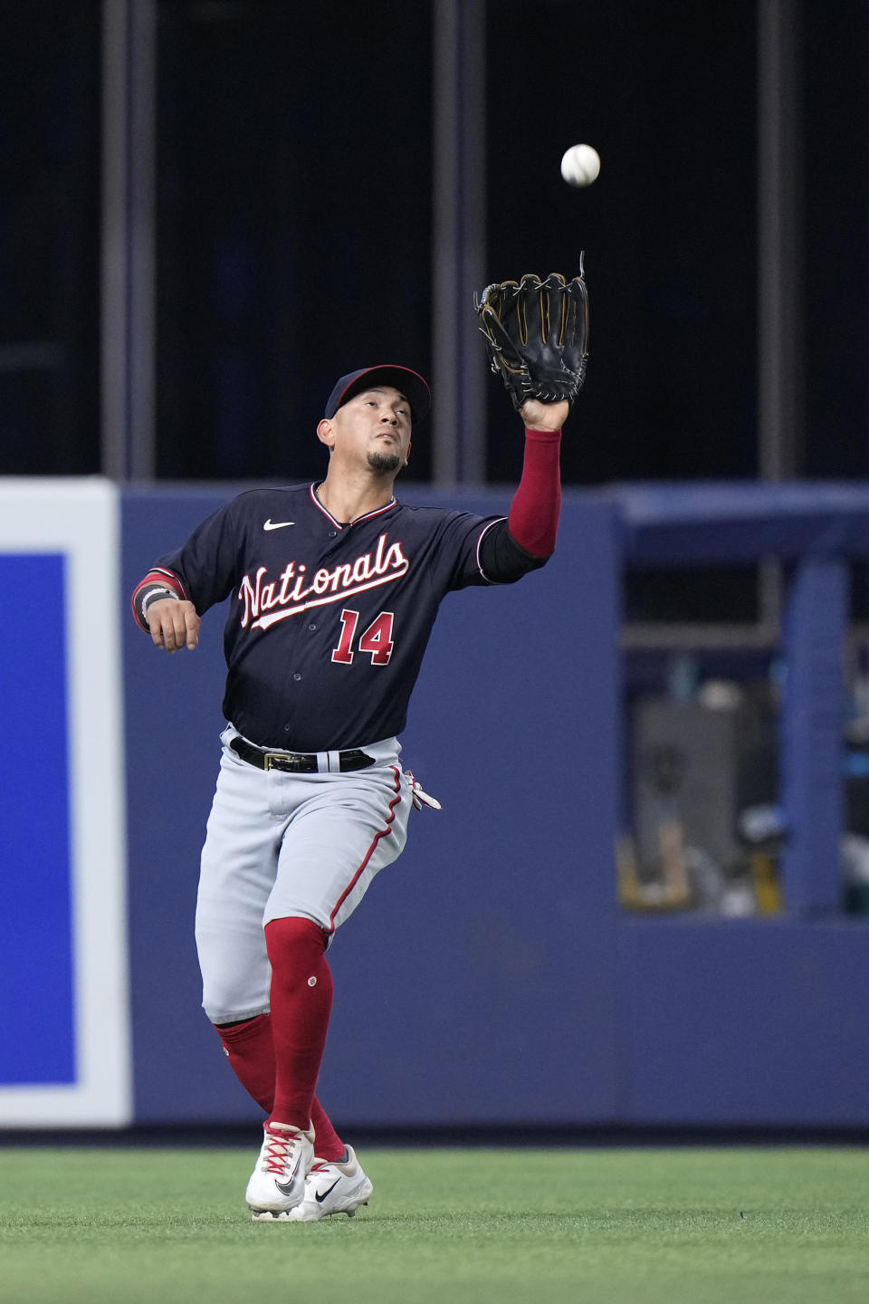 Washington Nationals left fielder Ildemaro Vargas catches a ball hit by Miami Marlins' Luis Arraez during the first inning of a baseball game, Friday, Aug. 25, 2023, in Miami. (AP Photo/Wilfredo Lee)