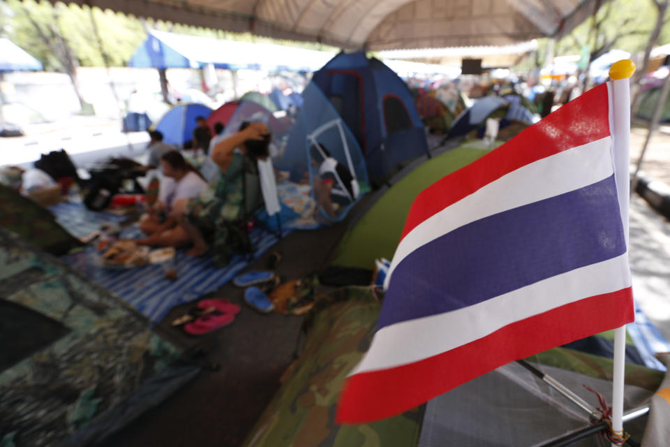 Anti-government protesters spend time at a camp site in downtown Bangkok, Thailand, Sunday, May 11, 2014. Thai anti-government protesters who have been camped out in several locations in Bangkok packed their tents as they ramped up their efforts to bring down what remains of Prime Minister Yingluck Shinawatra's administration by laying siege to television stations, surrounding state offices and demanding lawmakers help them install a non-elected prime minister to rule the country. (AP Photo/Vincent Thian)