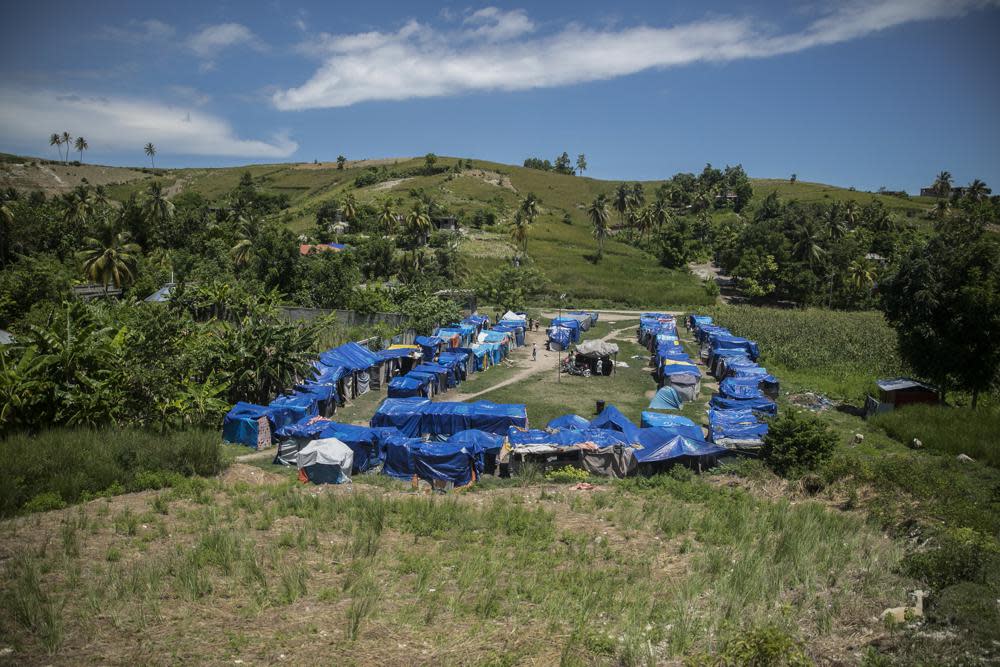 Blue tarps serve as roof coverings in Camp Devirel set up by earthquake refugees in Les Cayes, Haiti, Wednesday, Aug. 17, 2022. (AP Photo/Odelyn Joseph)